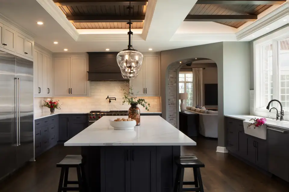 Kitchen and bath remodeling Mequon: Bonniwell kitchen with coffered wood ceiling, arched doorway, dark island and glass pendant light