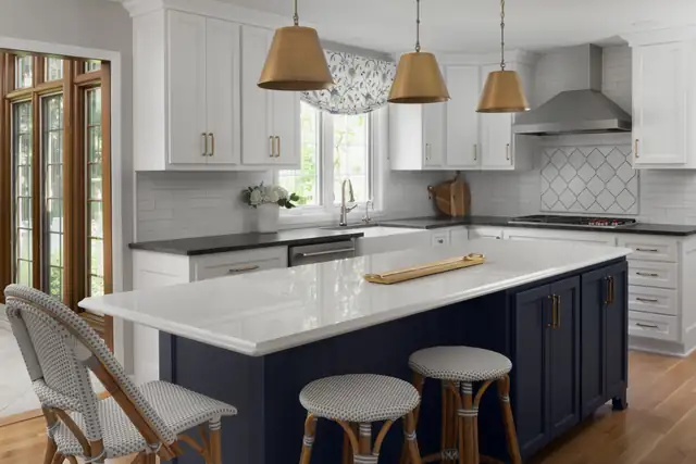 Lamplighter Lane kitchen with navy island, white quartz top, brass dome pendants and white shaker cabinets